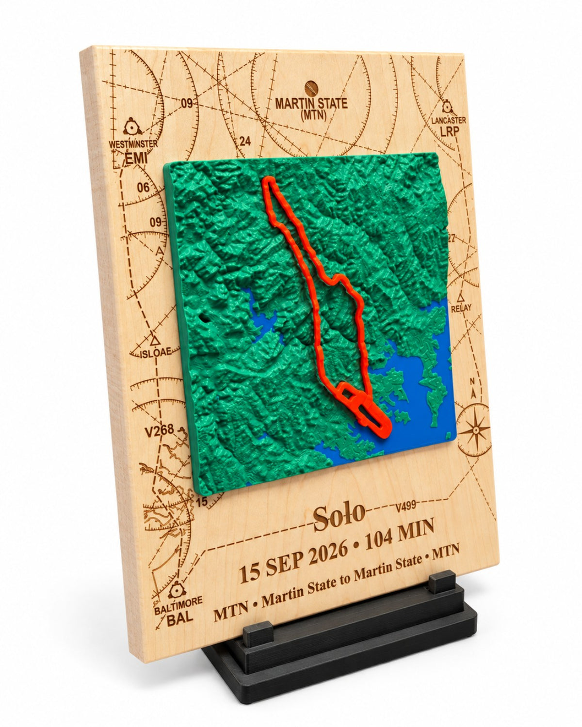 Angled view of Martin State solo flight keepsake with raised 3D terrain, red flight path and black display stand.
