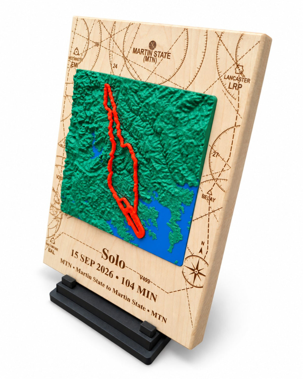 Three-quarter view of personalized Martin State solo flight plaque showing raised terrain, engraved maple and stand.