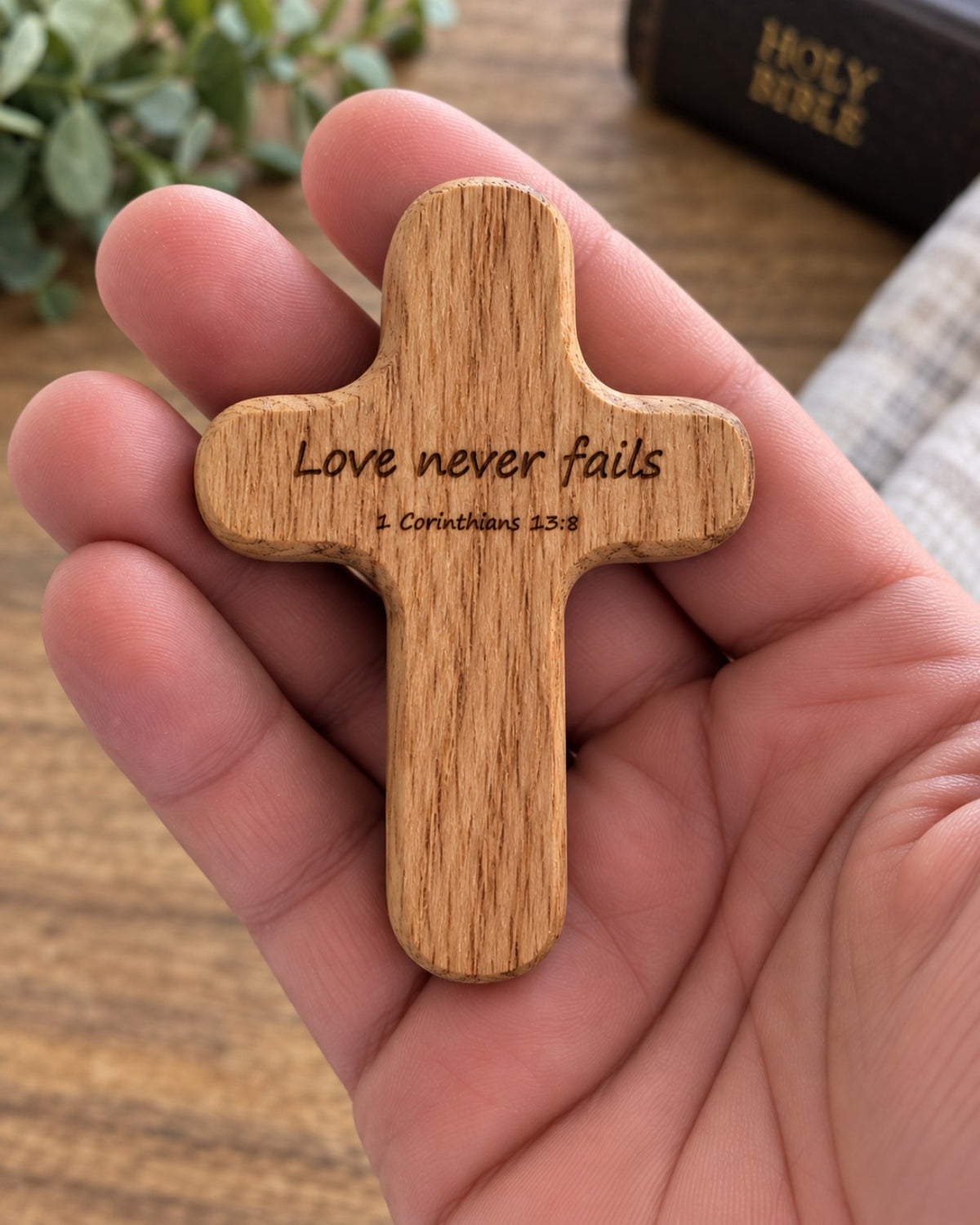 Red Oak pocket cross engraved Love never fails 1 Corinthians 13:8