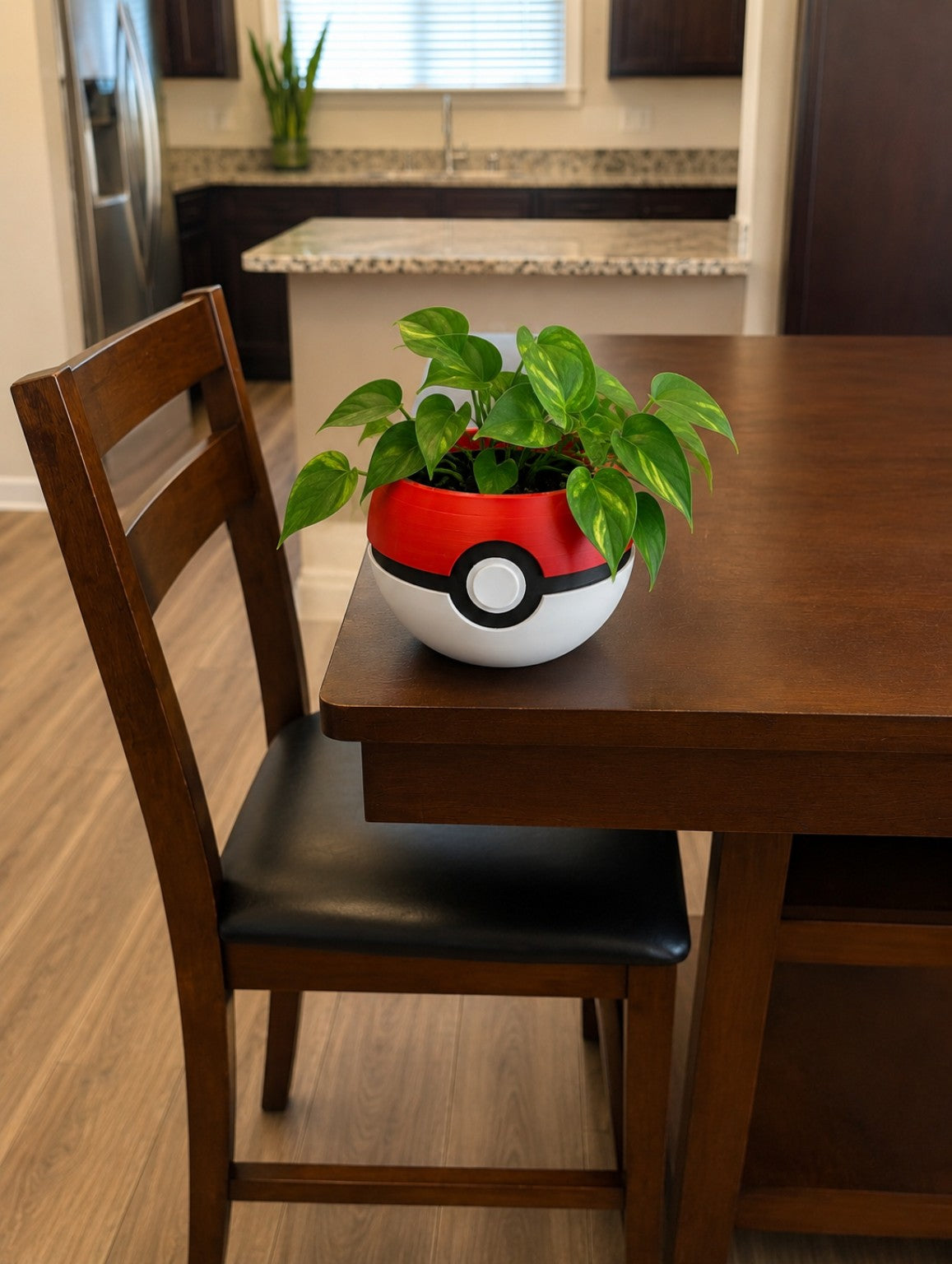 Pokeball inspired 3D printed planter with pothos plant