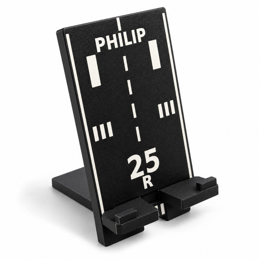 Black personalized runway phone stand showing 25R and PHILIP, angled view